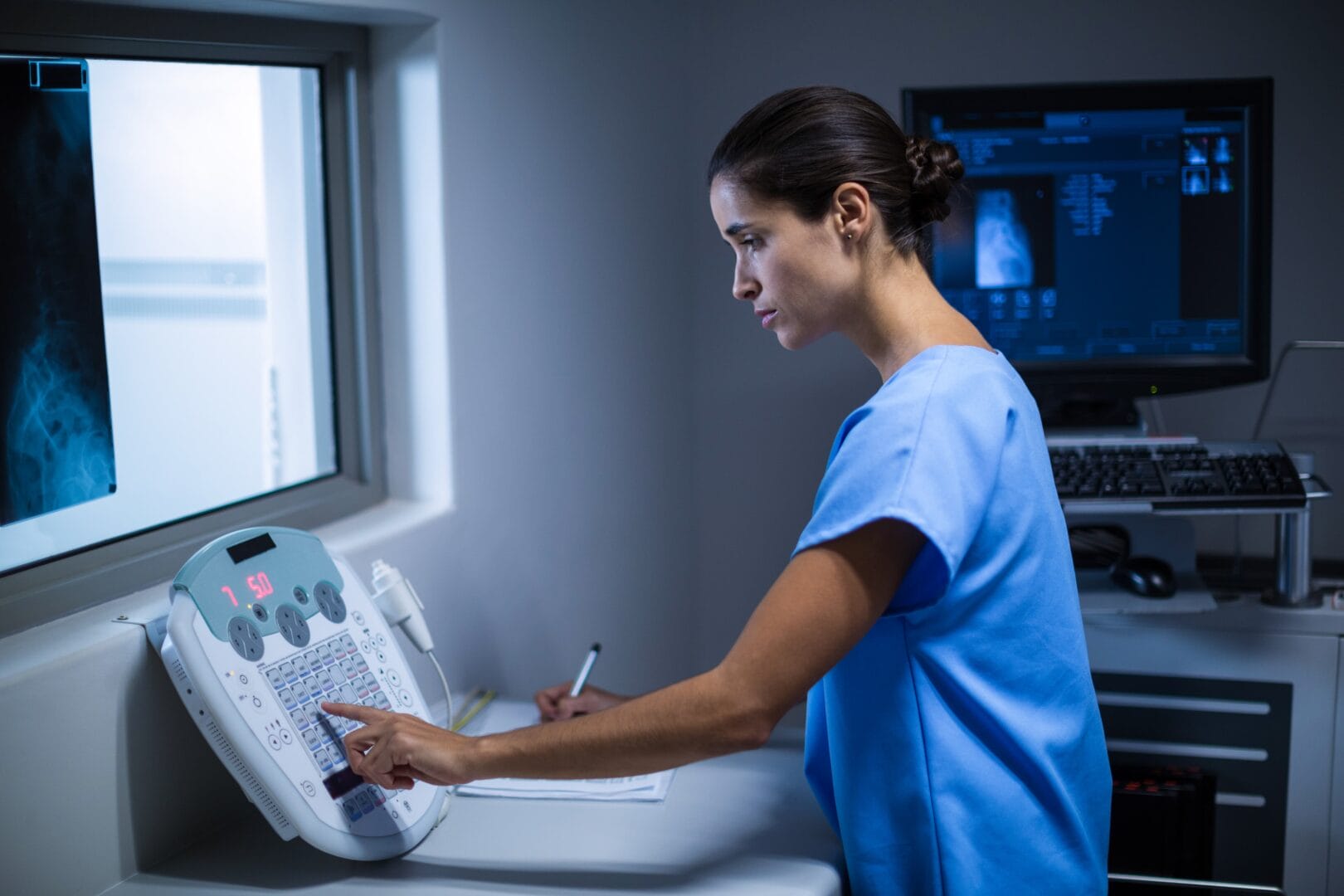 nurse taking notes x ray room 1